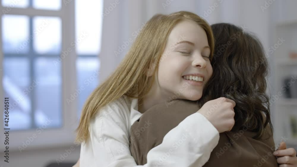 Young sisters talking and hugging, feeling happy, trustful relationship Young sisters talking and hugging, feeling happy, trustful relationship