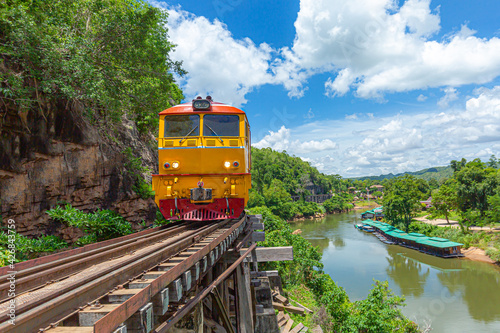 trains running on death railways track crossing kwai river in kanchanaburi thailand this railways important destination of world war II history builted by soldier prisoners photo