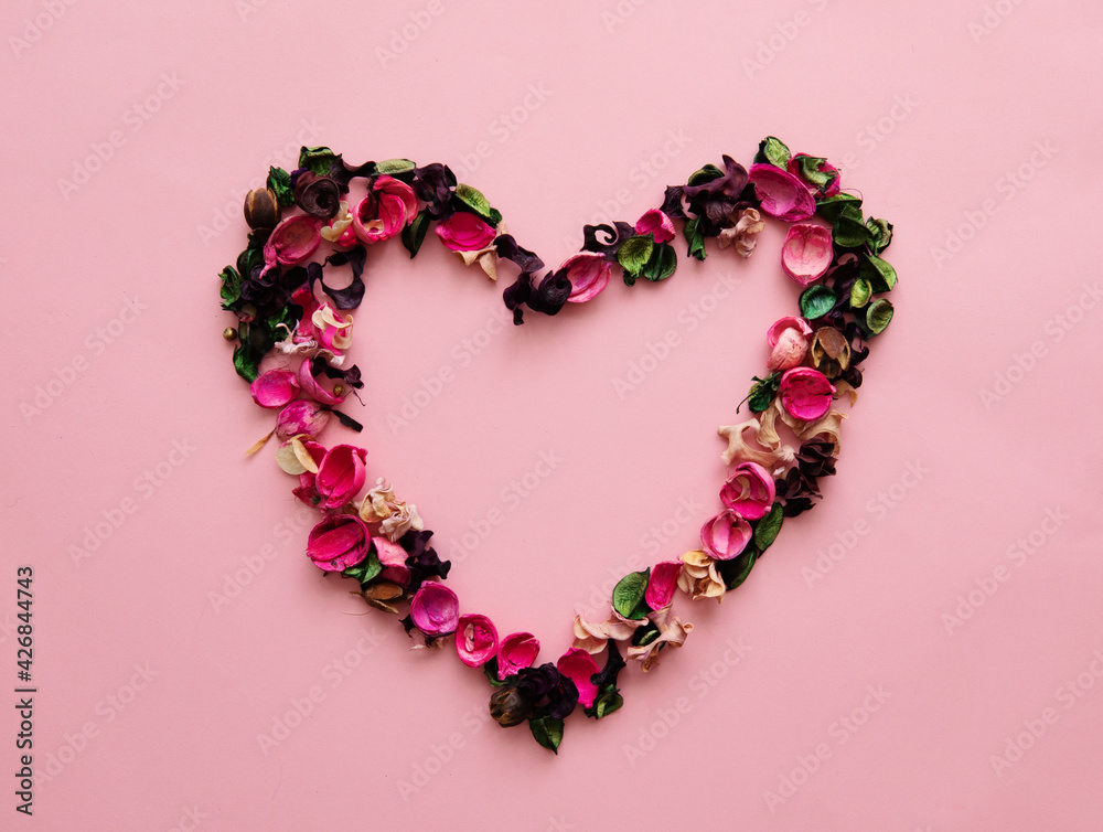 floral arrangement of pink flowers heart isolated background with place for text.