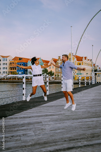 Curacao Willemstad March 2021, sunset at the colorful city of Willemstad with people walking at the flooten bridge photo