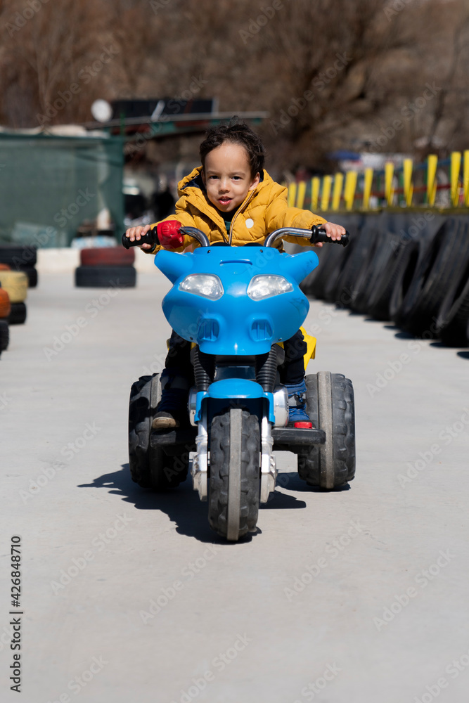 young children are getting traffic education with fun. girl and boy are having fun driving battery cars. young children are getting traffic education with fun. girl and boy are having fun driving battery cars.