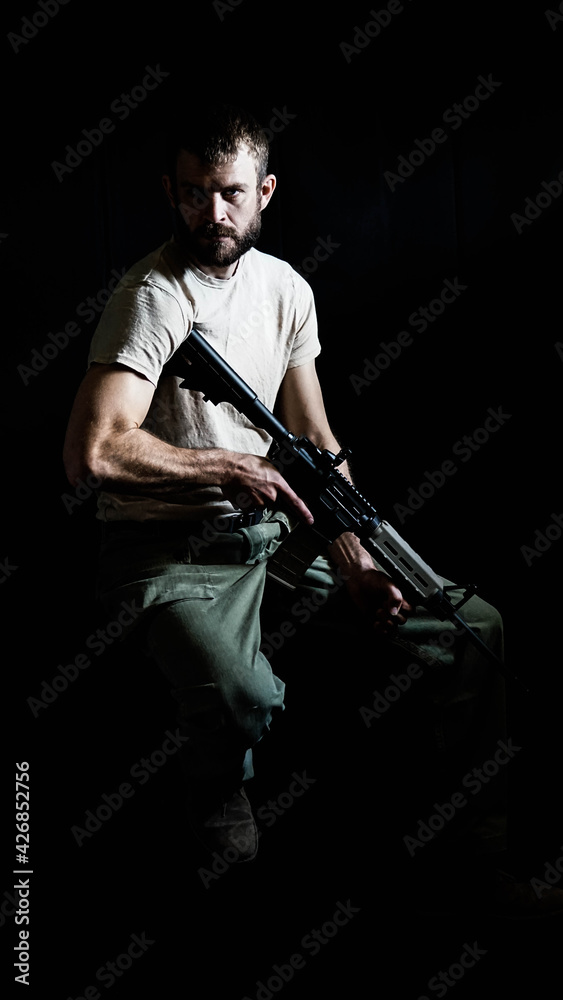 Portrait of an American Army veteran holding an AR15 Rifle. Portrait of an American Army veteran holding an AR15 Rifle.