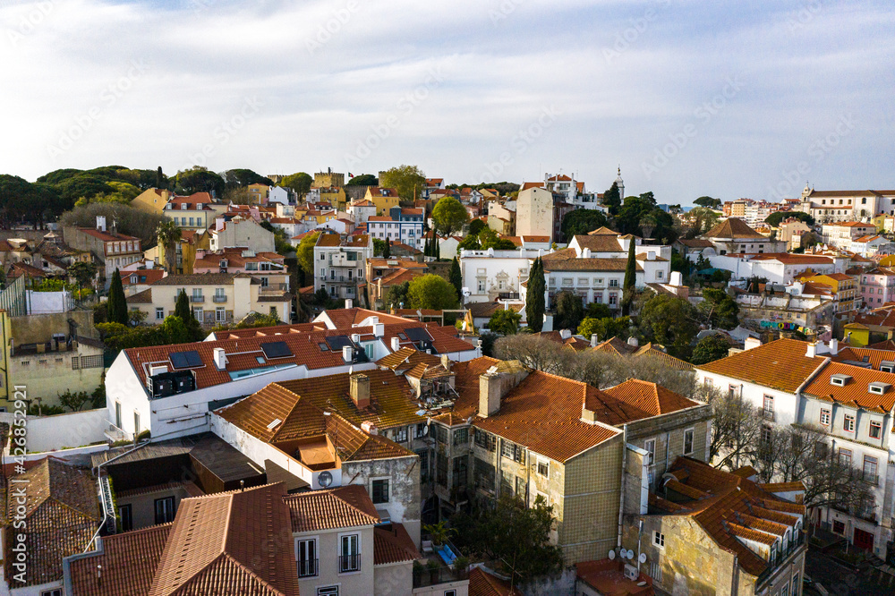 Aerial drone view over Alfama District, Lisbon, Portugal. Lockdown cityscape. São Jorge Castle in the background.