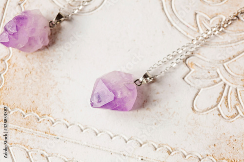 Amethyst raw stone pendant on silver chain photo