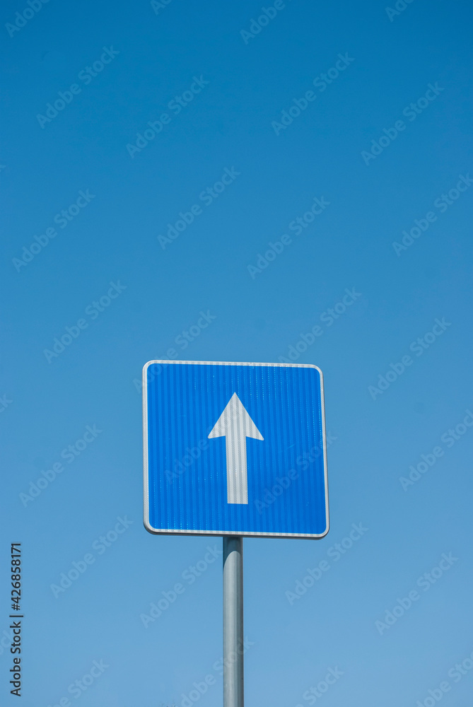 Blue rectangle one way road traffic sign closeup on blue sky background Blue rectangle one way road traffic sign closeup on blue sky background