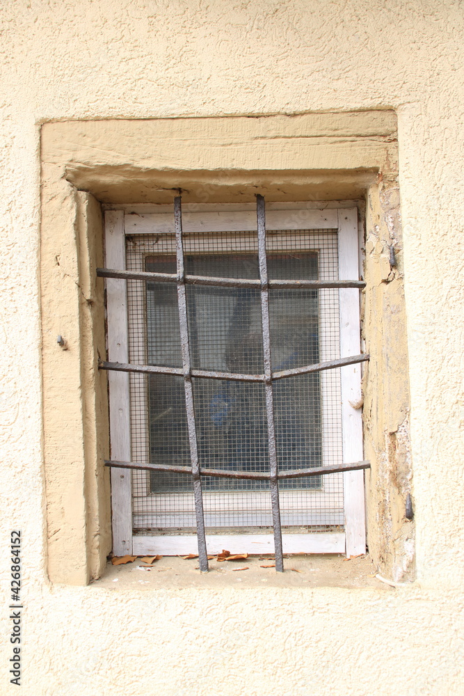 Fenster ist mit einem Metallgitter gegen Einbrecher geschützt