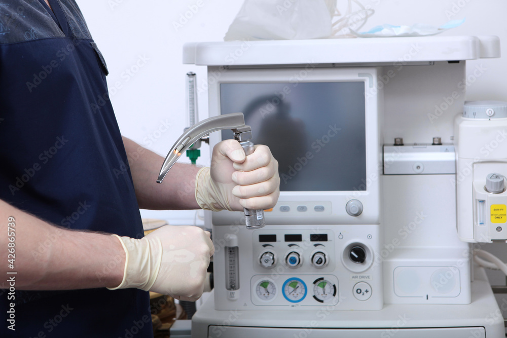 Laryngoscope in hands of an anesthesiologist. Tracheal intubation