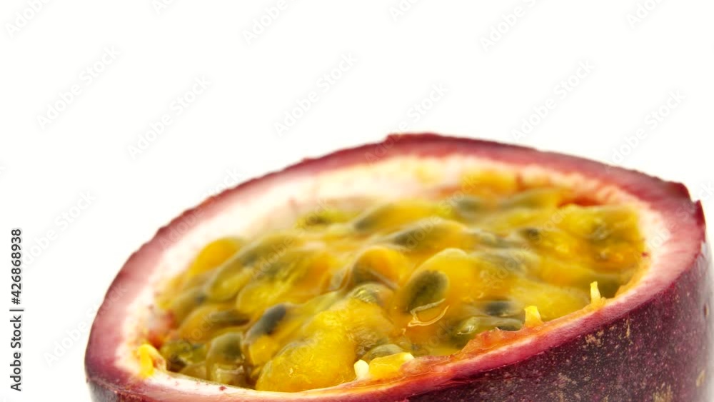 4K cross-section of a puple passion fruit Macro shot of sliced fresh exotic passion fruit fruit rotating isolated on white background 4K cross-section of a puple passion fruit Macro shot of sliced fresh exotic passion fruit fruit rotating isolated on white background