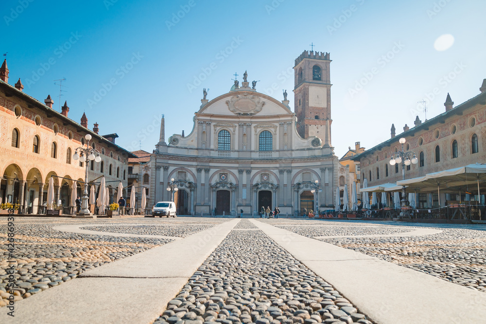 Square of the Cathedral of Sant'Ambrogio (Duomo di Vigevano) by day, blue sky