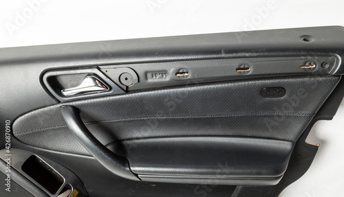 Car door trim with black leather upholstery on a white isolated background for repair and replacement in a car service. Spare parts catalog. © Aleksandr Kondratov