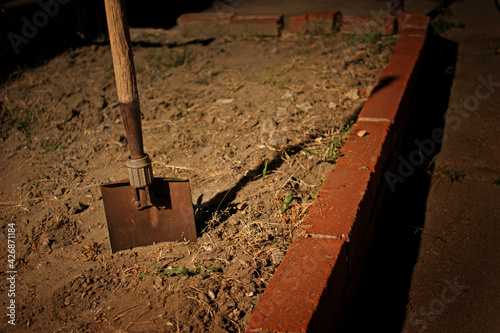 Horror scene with shovel at night after burying something