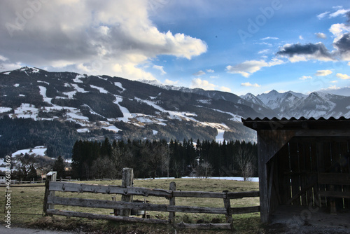 Shed in front of majestic mountains in spring