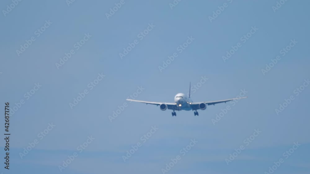 Airplane silhouette in the sunny sky Airplane silhouette in the sunny sky