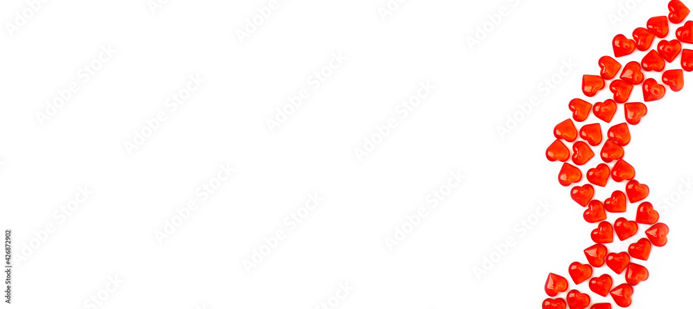 Red hearts on a white background form a pattern, ornament. Banner for congratulating a loved one. Place for text Red hearts on a white background form a pattern, ornament. Banner for congratulating a loved one. Place for text