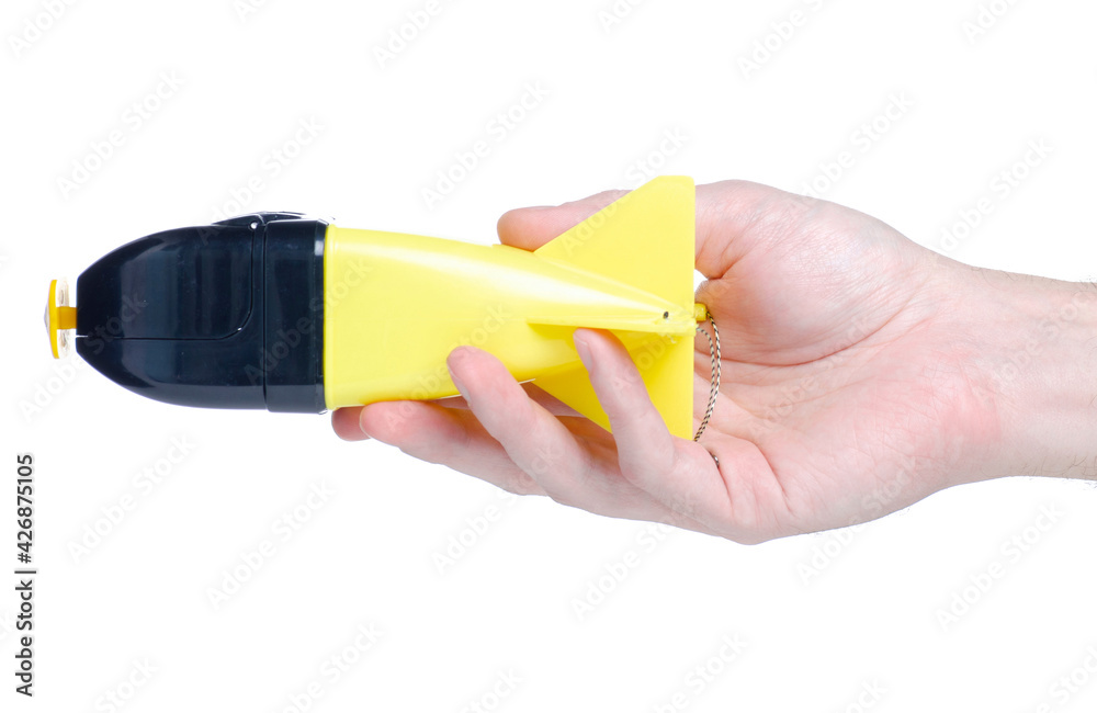 Fish feeder in hand on white background isolation Fish feeder in hand on white background isolation