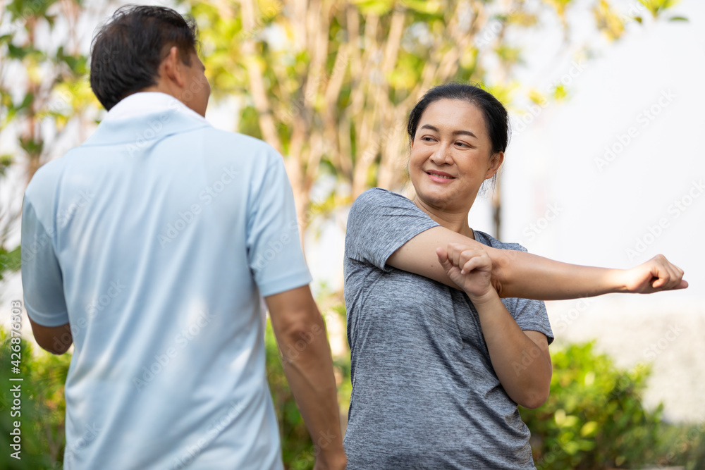 senior asian woman stretching and exercising outdoors senior asian woman stretching and exercising outdoors