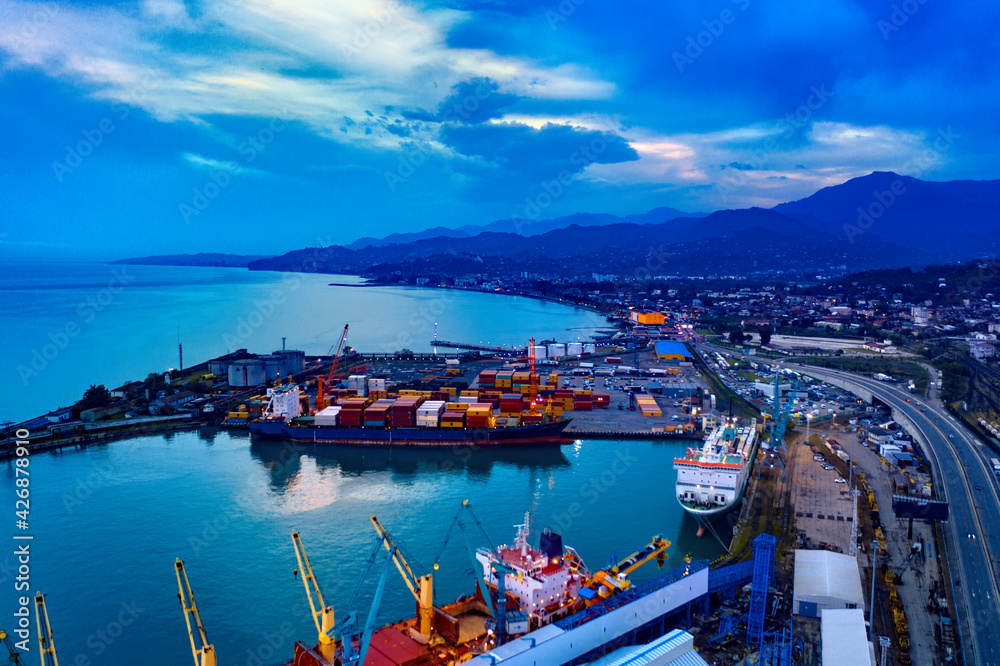 Batumi, Georgia - April 7, 2021: Batumi port, view of the city center from a cargo ship in the port in bright summer sunset lights