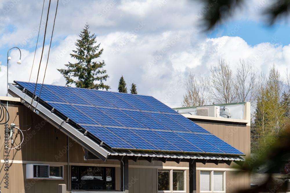Fototapeta premium Solar Panels Installed on Entry Roof of a Local Business