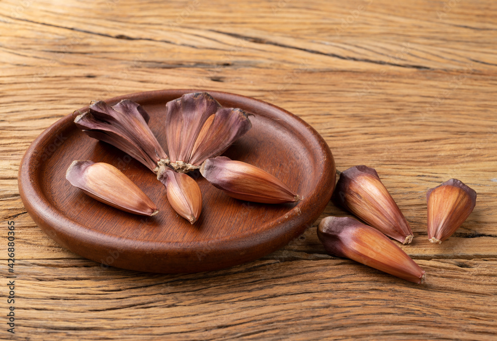 Araucaria pine tree seeds over wooden plate. Typical brazilian june festival ingredient Araucaria pine tree seeds over wooden plate. Typical brazilian june festival ingredient