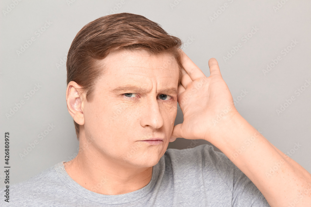 Portrait of charismatic blond mature man smoothing his hair with hand Portrait of charismatic blond mature man smoothing his hair with hand