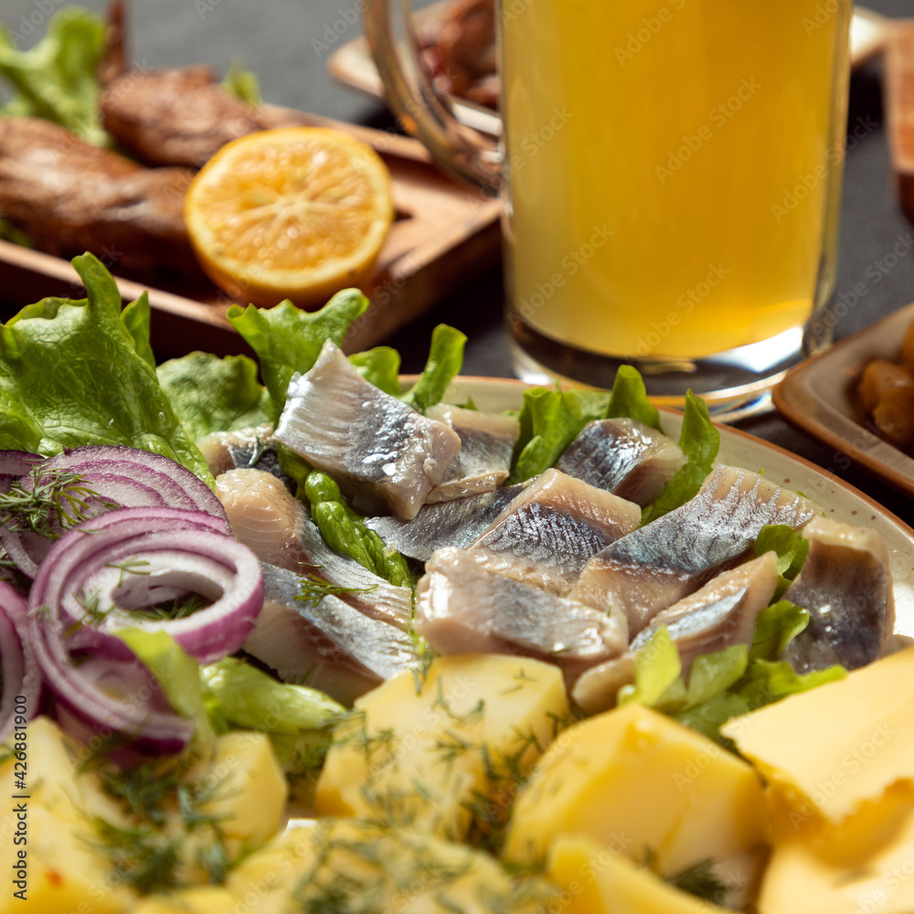 Grilled salted fish with potato and onion close up Grilled salted fish with potato and onion close up