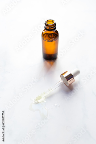 Retinol oil serum oil beauty care on isolated marble background photo