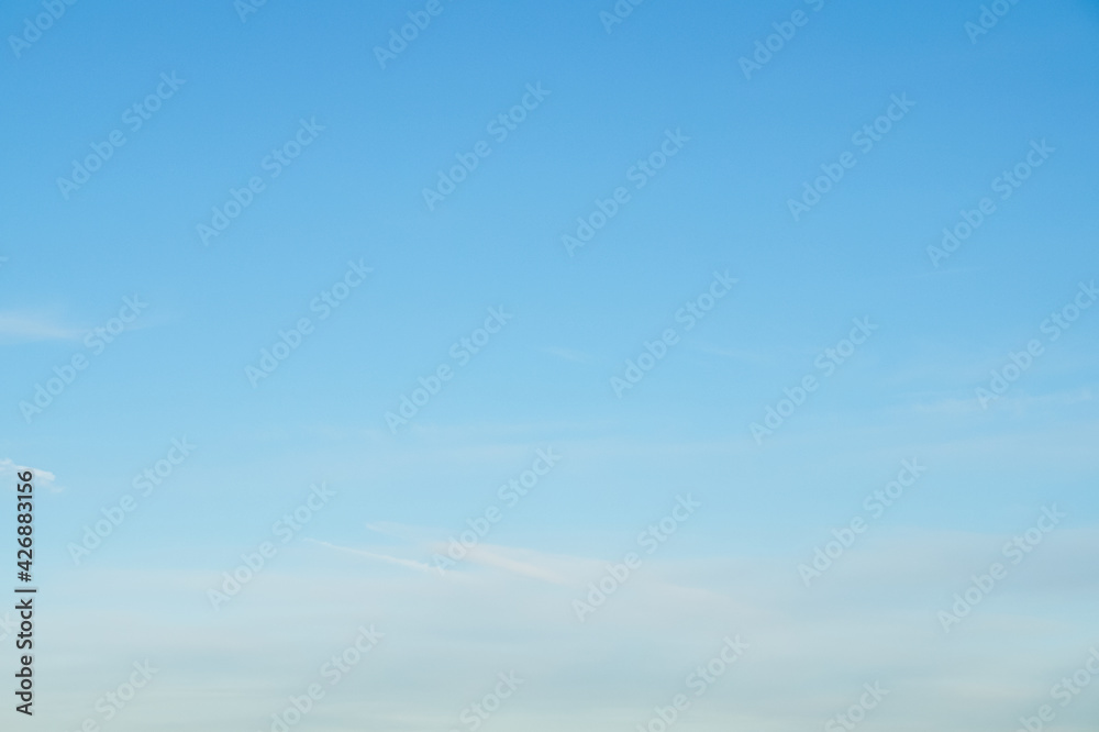 bright blue sky with soft clouds background