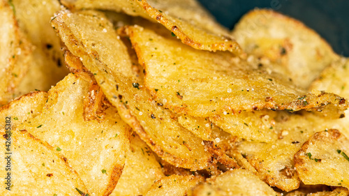 Natural fat potato chips with salt, black pepper, herbs and vegetable oil