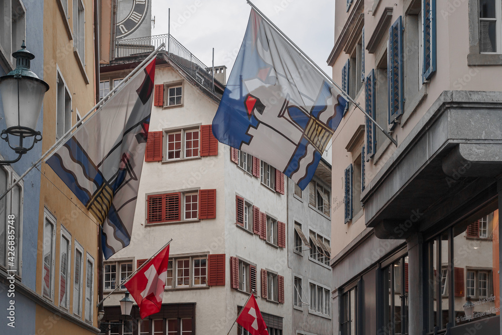 Facades of houses with flags in old Zurich, Switzerland