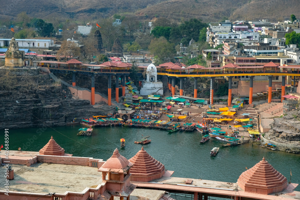 Fototapeta premium Omkareshwar, India - March 2021: Views of Omkareshwar from Mandhata Island located on the Narmada River on March 20, 2021 in Madhya Pradesh, India.