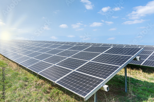 Photovoltaic park: Solar paneles with warm a blue sky.  Renewable energies