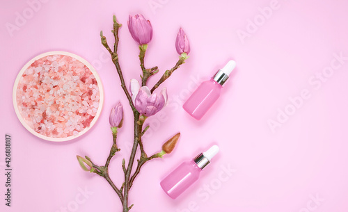 Cosmetic skincare background. Herbal medicine with magnolia flowers, pink cosmetic salt. Natural skincare background. Homemade remedies for the spa