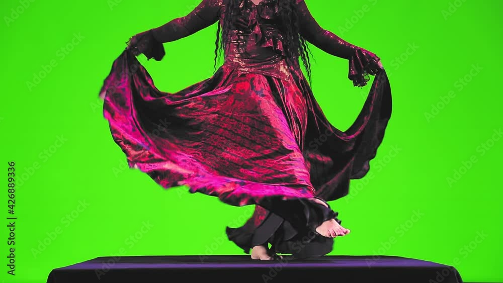 A barefoot gypsy woman without a face with long black hair in a red ...
