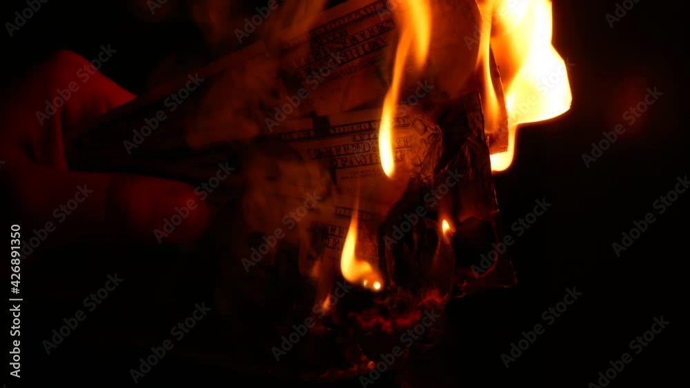 Man is burning Dollars money. Greedy corruption concept. Bribe idea. Inflation rates. Price growth. Economic crisis. Man is burning Dollars money. Greedy corruption concept. Bribe idea. Inflation rates. Price growth. Economic crisis.