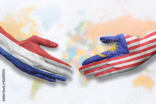 Malaysia and the Netherlands - Flag handshake symbolizing partnership and cooperation