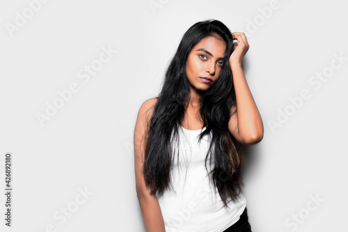 Portrait of a beautiful Asian pretty woman with long straight black hair, brown eyes posing, background