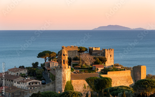 Italy Tuscany Castiglione della Pescaia, panoramic sunset views of the Castle, in the background the island of Giglio