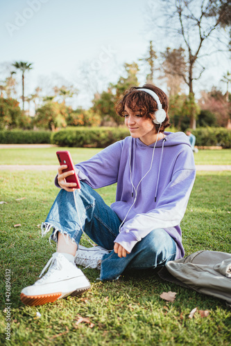 Teenager listening to music in the park