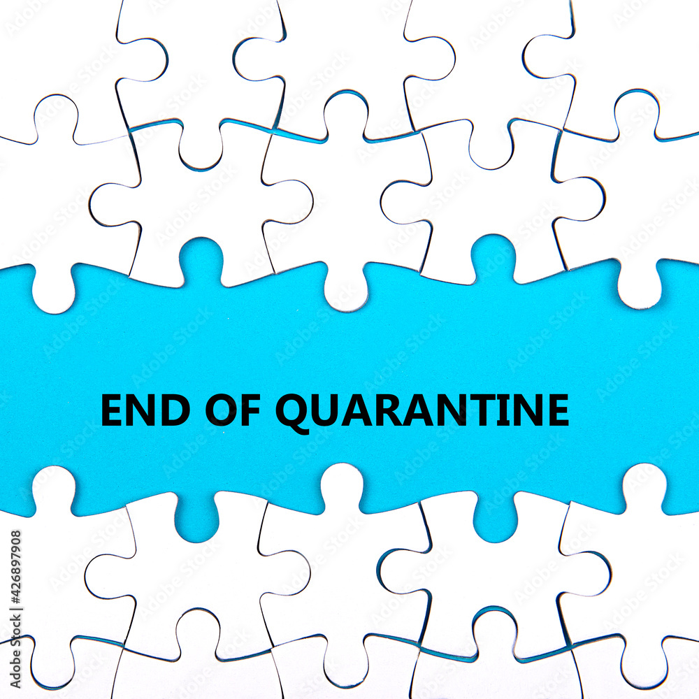 White puzzle background with pieces missing. Words END OF QUARANTINE. End of coronavirus and quarantine concept White puzzle background with pieces missing. Words END OF QUARANTINE. End of coronavirus and quarantine concept
