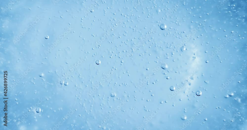 Oxygen bubbles in water on a blue abstract background Oxygen bubbles in water on a blue abstract background