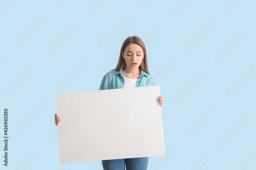 Beautiful young woman with blank poster on color background Beautiful young woman with blank poster on color background