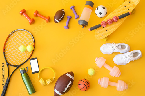 Fototapeta Naklejka Na Ścianę i Meble -  Frame made of sport equipment on color background