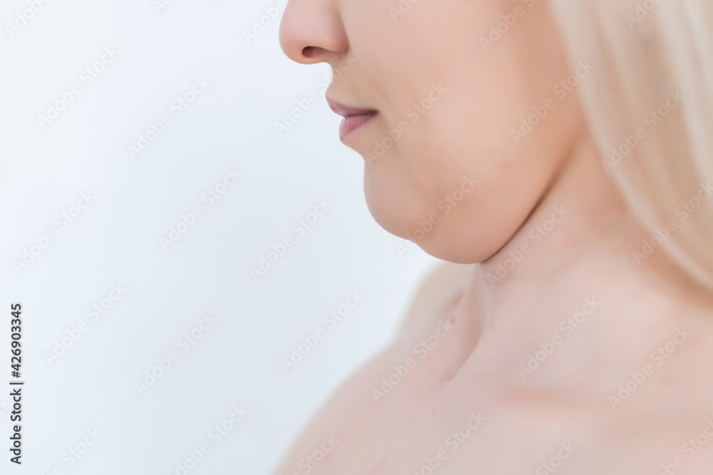 Closeup of woman's secong chin, problems with excess weight. Woman is touching her chin to demostrate her cosmetic problem. Examining double chin, need facial line correction Closeup of woman's secong chin, problems with excess weight. Woman is touching her chin to demostrate her cosmetic problem. Examining double chin, need facial line correction