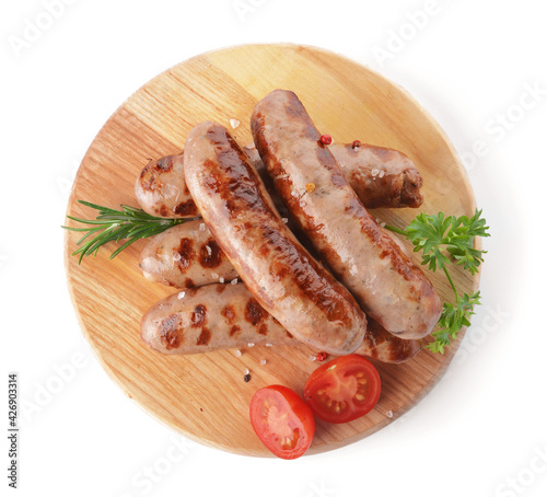 Board with delicious grilled sausages on white background