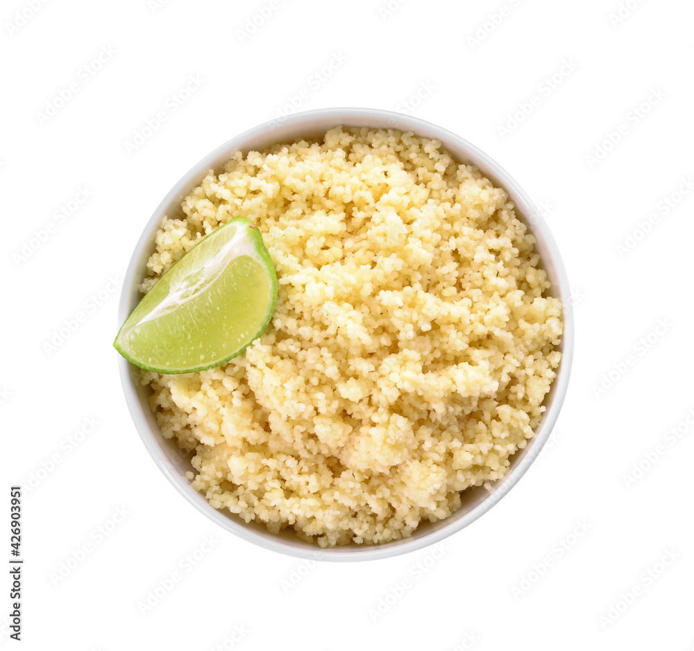 Bowl with tasty couscous and lime on white background