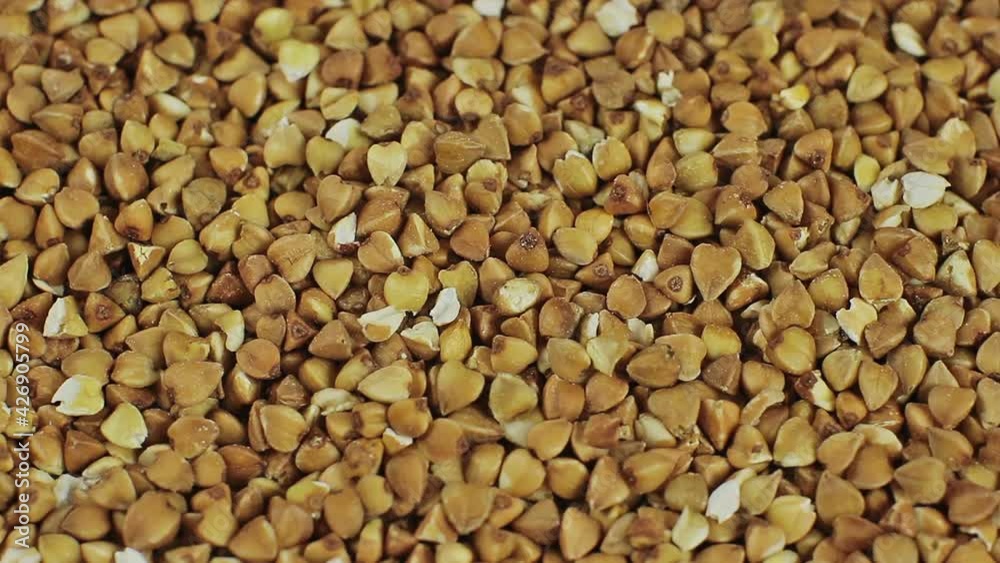 Background from the scattered buckwheat, close up rotation Background from the scattered buckwheat, close up rotation