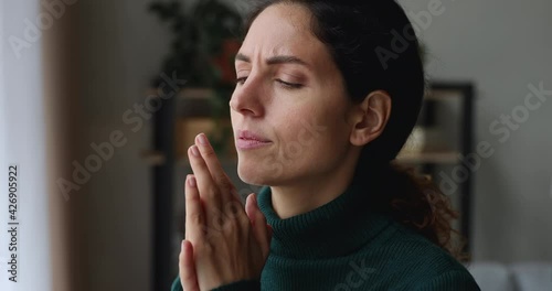 Side headshot view stressed young caucasian woman massaging temples, suffering from headache or thinking of difficult problem solution looking in distance, feeling doubtful unhappy alone at home.