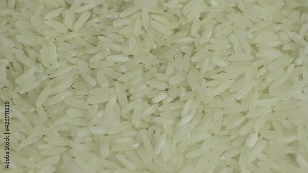 White long rice background, uncooked raw cereals, macro close-up rotation White long rice background, uncooked raw cereals, macro close-up rotation