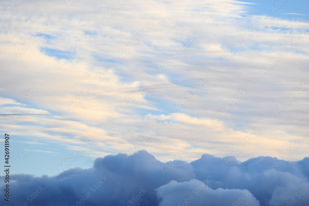 Obraz premium Cloudscape both with light and airy clouds, and ominous dark clouds, as a nature background 