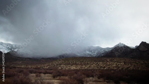 Rain clouds over snowy Arizona mountain